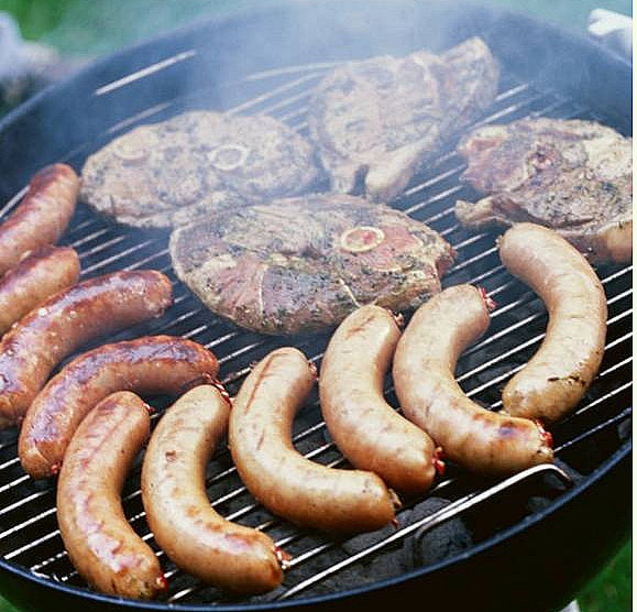 Sausages and lamb steaks on the grill.
