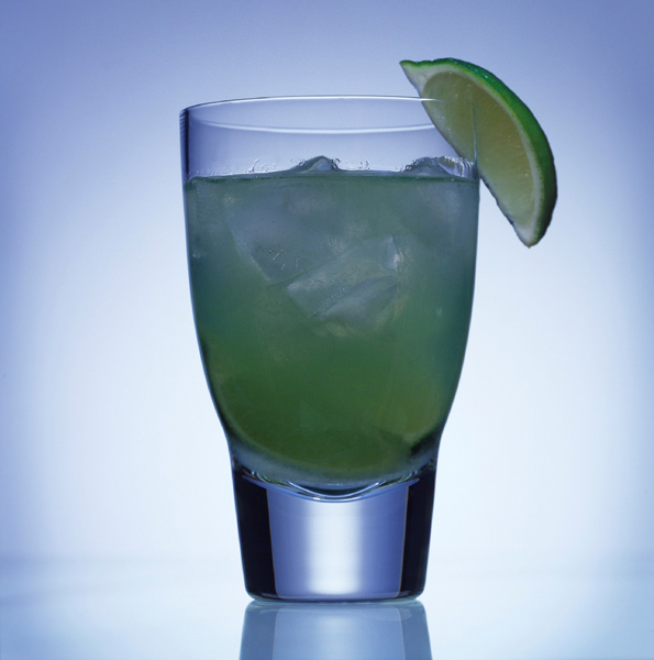 A glass with the drink surfer's paradise, a refreshing combination with lime.