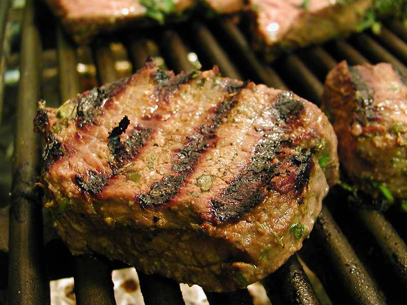 Marinated fillet steak on the grill.