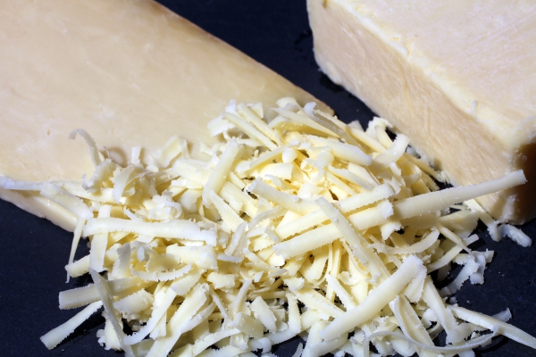 Cheddar cheese, whole, a slice and grated.