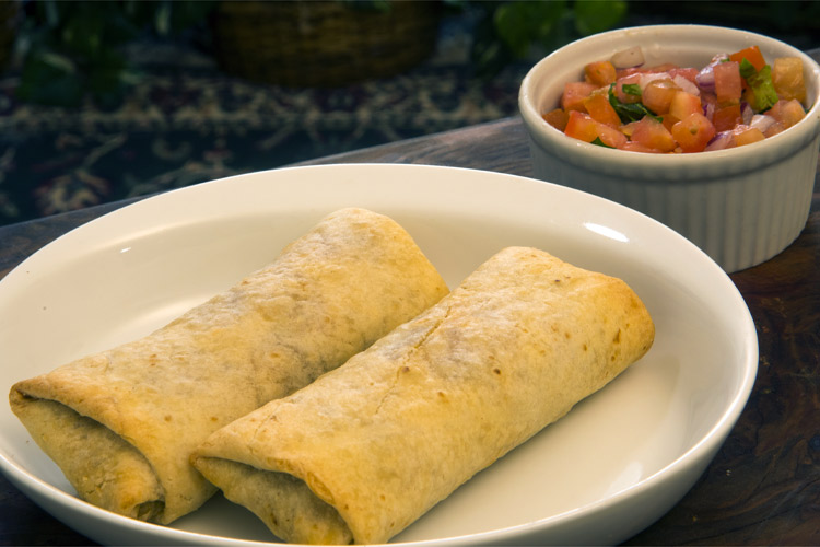 Two chimichangas and a bowl of salsa.