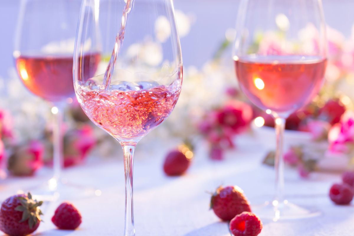 Glasses of rosé wines among berries.