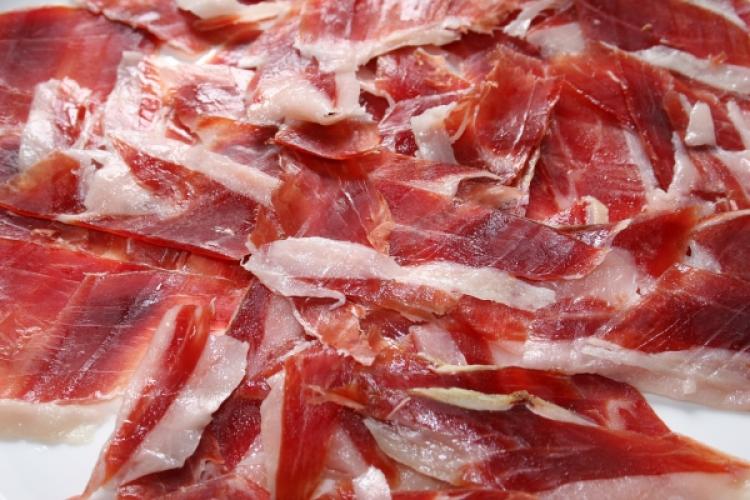 A plate of Iberico serrano ham cut into thin slices.
