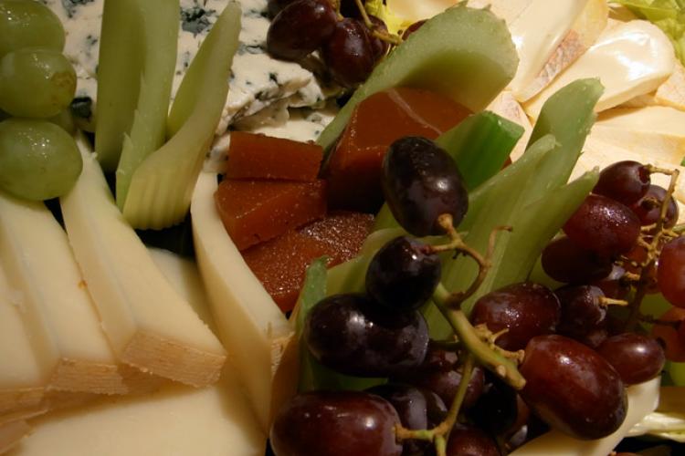 A cheese board with fruit.