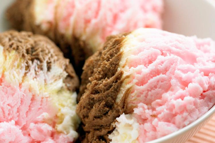 Three scoops of strawberry, vanilla and chocolate ice cream.