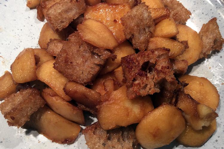 Close up of fried apples and bread.