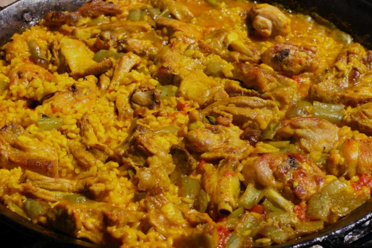 Paella rice cooked over open fire.