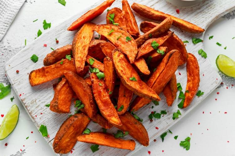 Top view of thinly cut roasted sweet potato wedges.