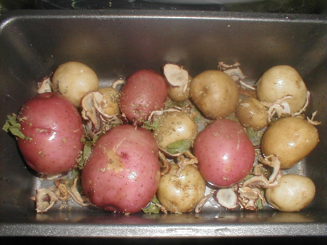 Roast potatoes in oven tray.