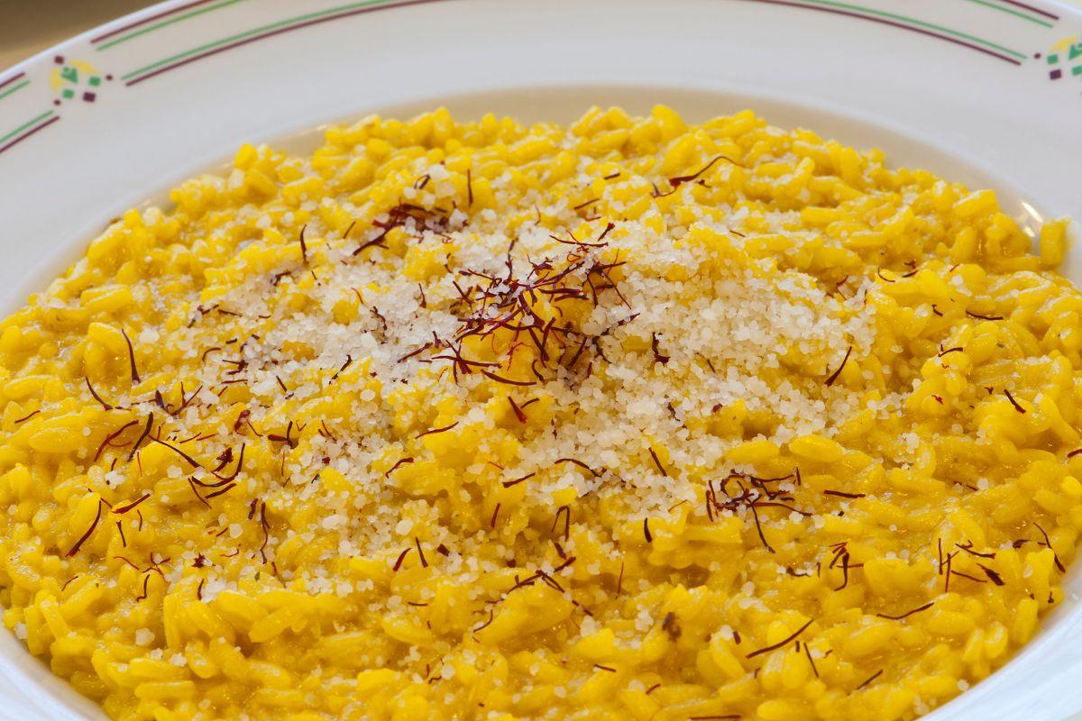 Risotto alla Milanese topped with grated cheese and saffron threads