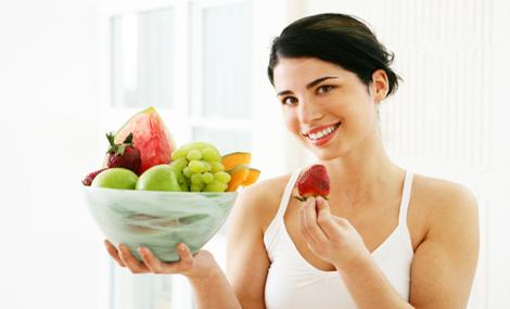 Woman with fruit bowl.