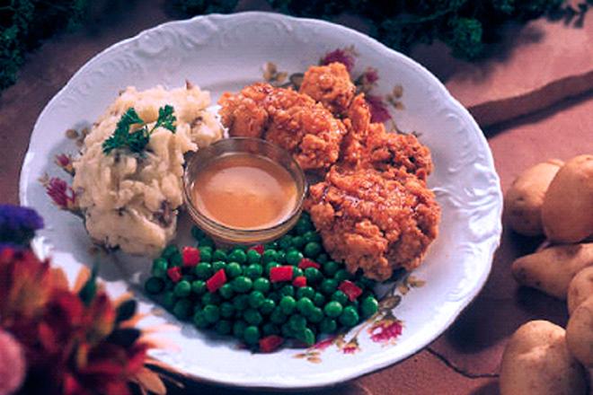 Chicken dinner with chicken meat, vegetables and sauce.