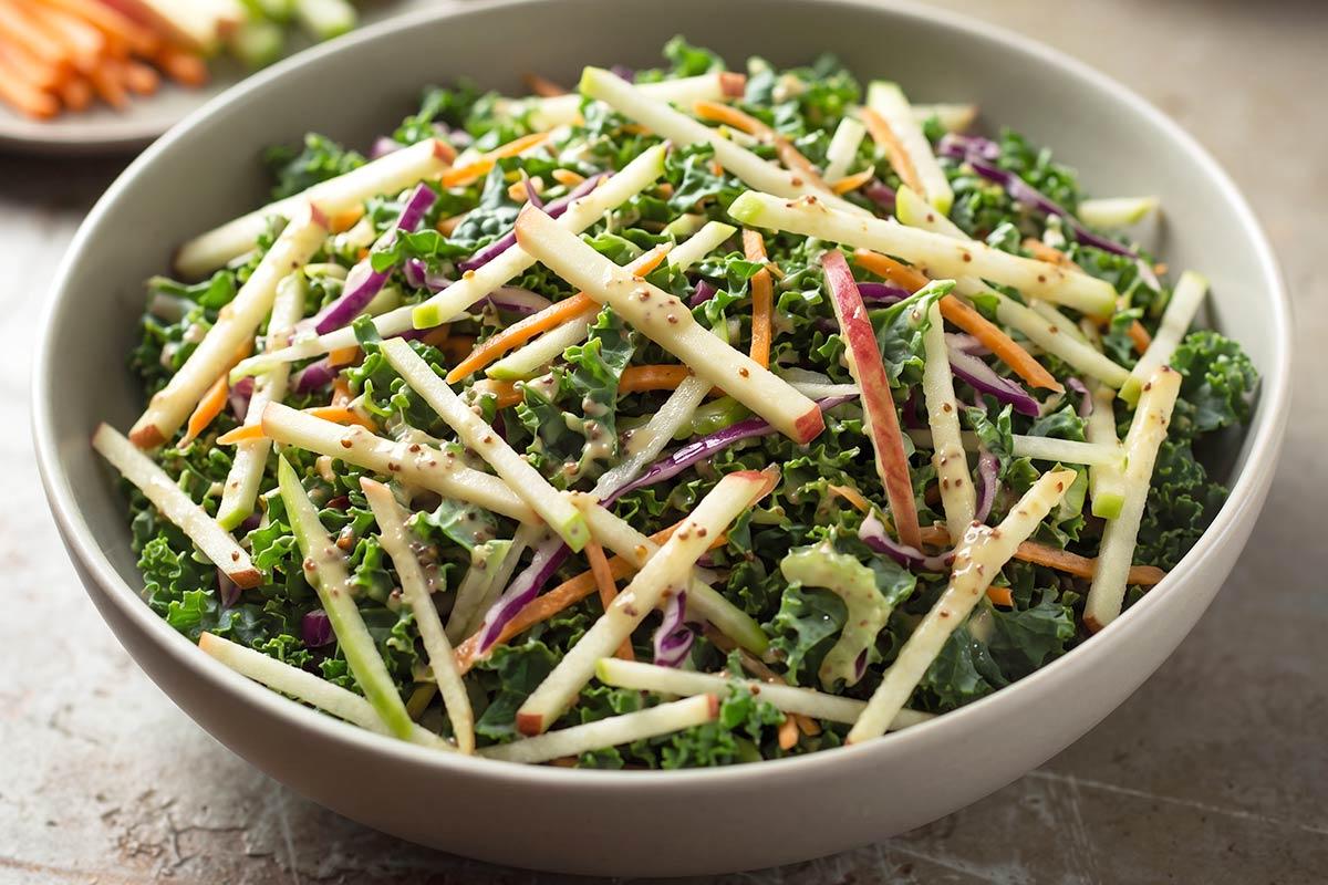 Kale and apple slaw with red cabbage and carrot, tossed in a creamy honey mustard dressing.