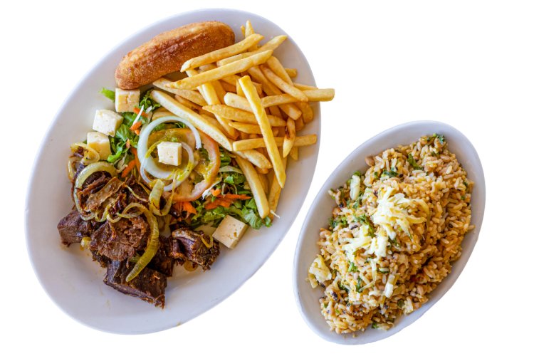 A Brazilian meal with meat, salad, French fries and fried banana.