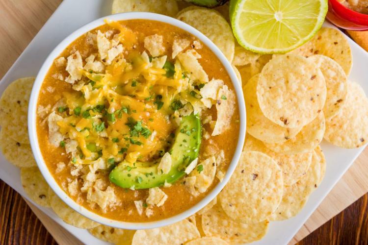 A bowl of chicken enchilada soup.