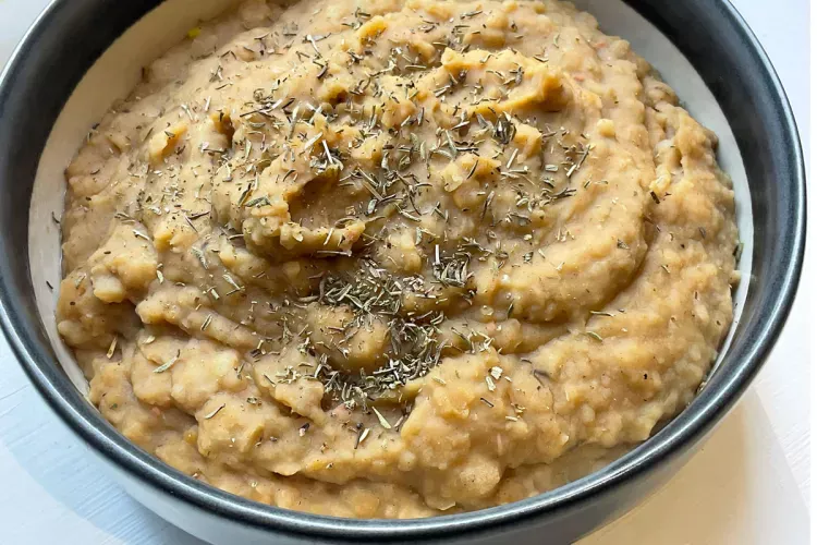 A bowl with smoky bean and herb mash.