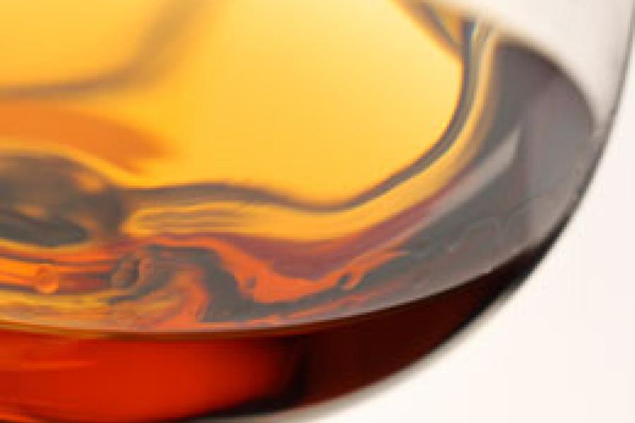 Detail of a brandy sniffer with some brandy.