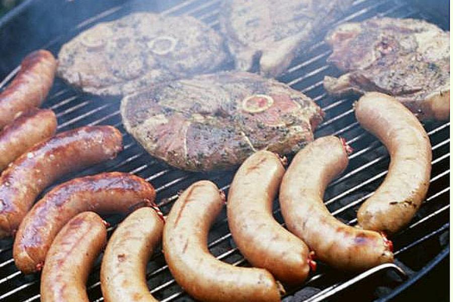 Sausages and lamb steaks on the grill.