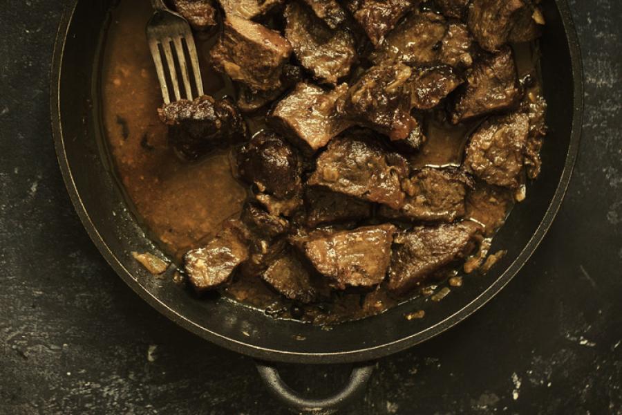 Stewed beef in a pan.