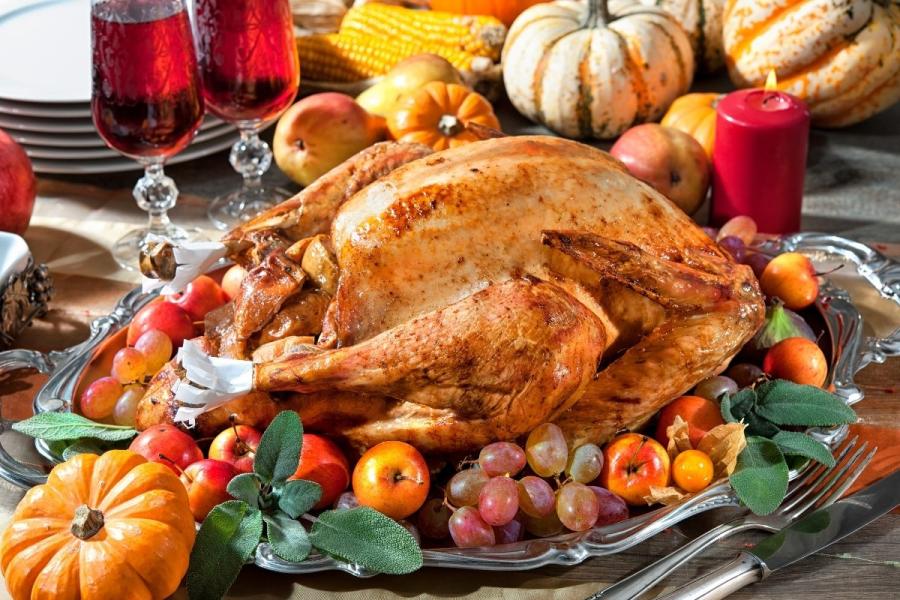 A Thanksgiving dinner with roast turkey accompanied of red wine.