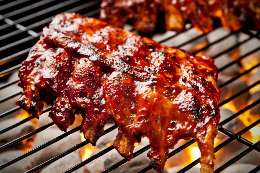 A rack of ribs cooking on the grill.
