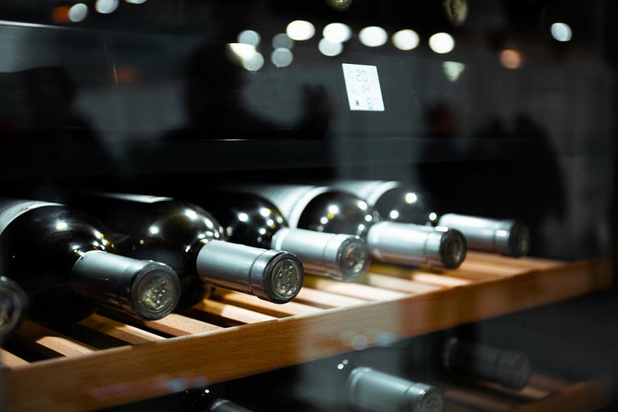 A wine cooler with some bottles of wine.