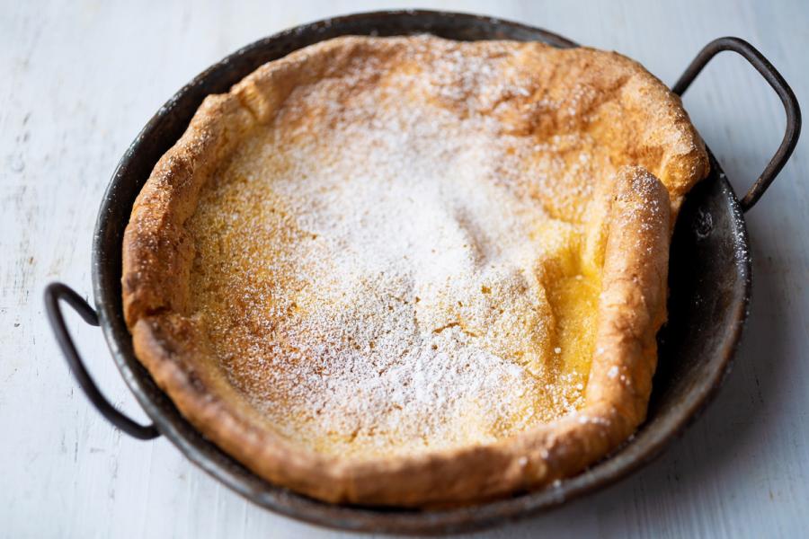 A Dutch baby pancake in a rustic pan.
