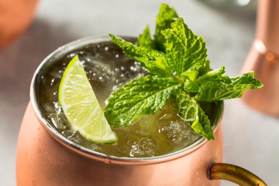 Irish Mule cocktail in a copper mug with crushed ice, garnished with fresh mint and a lime wedge.