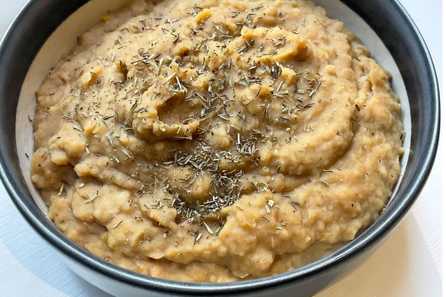 A bowl with smoky bean and herb mash.