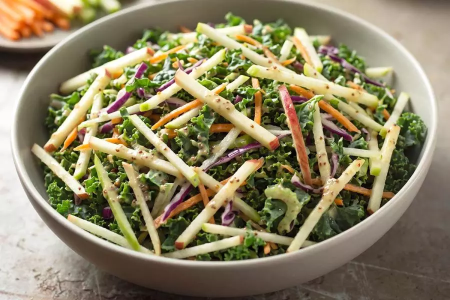 Kale and apple slaw with red cabbage and carrot, tossed in a creamy honey mustard dressing.