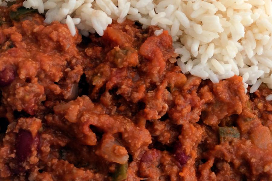 Close up of chili con carne with rice on the side.
