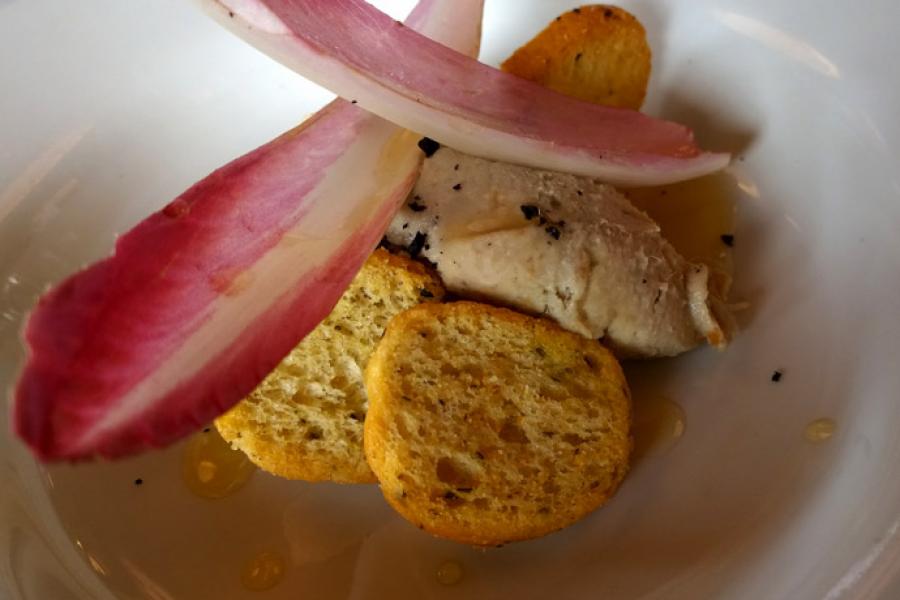 A plate with mackerel pate, purpel endive leaves and minitaure toasts.