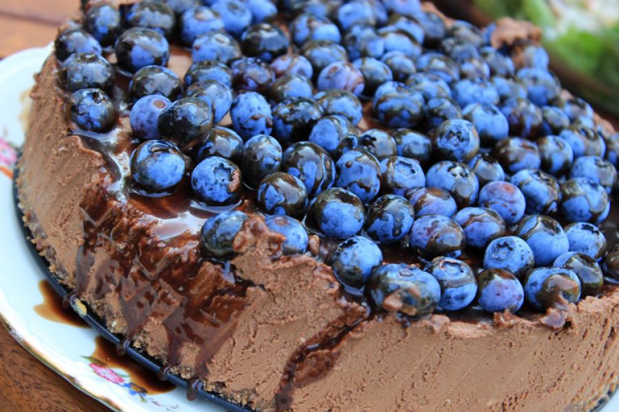 Chocolate espresso cheesecake decorated with blueberries.