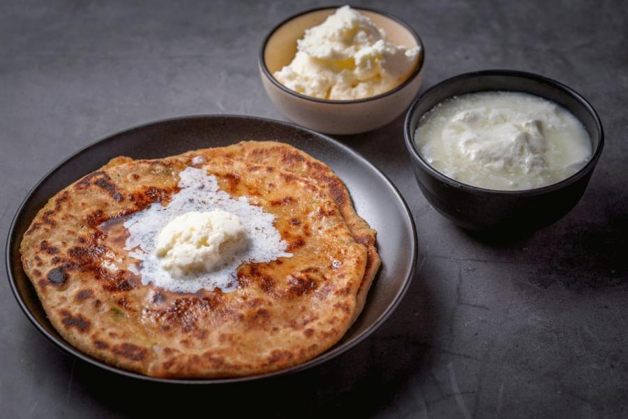 Aloo paratha with curd and white butter.