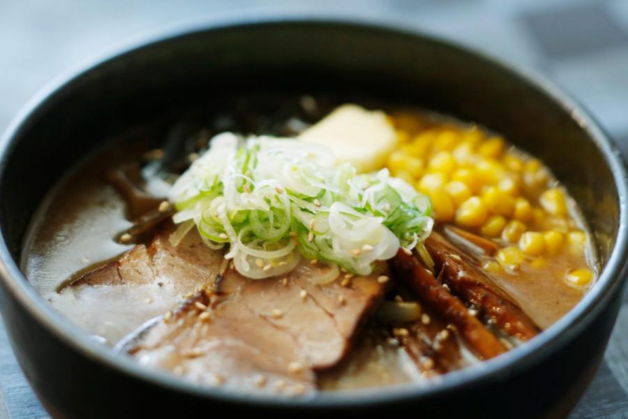 A bowl of Sapporo miso ramen with sliced pork, seaweed and corn.