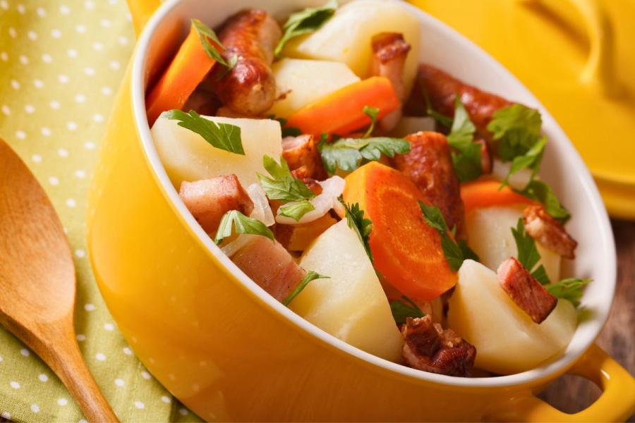 Tasty Irish coddle with pork sausages, bacon and vegetables.