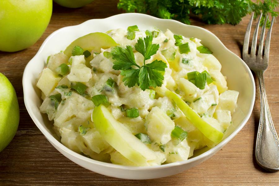 A bowl with Irish potato salad with apples.