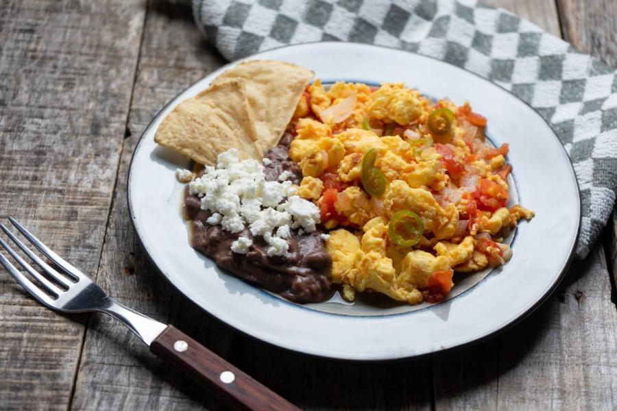 A plete of huevos con frijoles, scrambled eggs with beans.